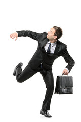 An afraid businessman running away isolated on white background