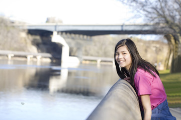 Girl standing on river bank