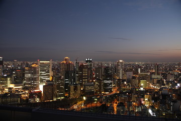 Obraz premium Illuminated Osaka City in Japan at night from high above