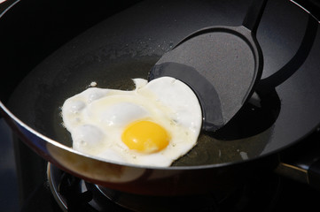 Macro closeup of an egg sizzling in a frying pan