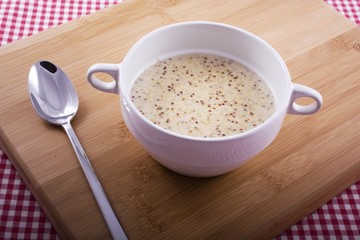 Bowl of Mustard Soup on Cutting Board