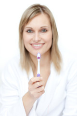 Portrait of a gorgeous woman brushing her teeth