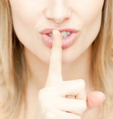 Close-up of a woman asking for silence