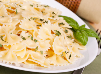 Bowtie pasta with a garnish of parsley and basil