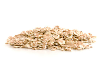 Organic wheat flakes isolated on white background.