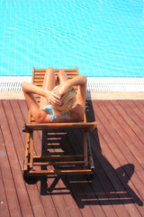 Fototapeta premium Beautiful young woman at a pool