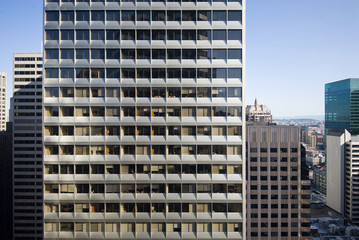 A repetitive building facade represents modern life