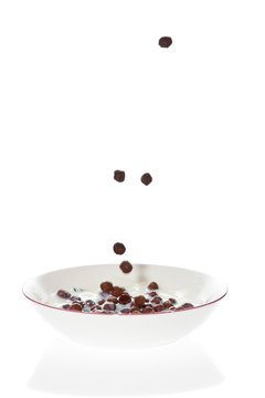 Chocolate Cereal Falling Into A Bowl Of Milk