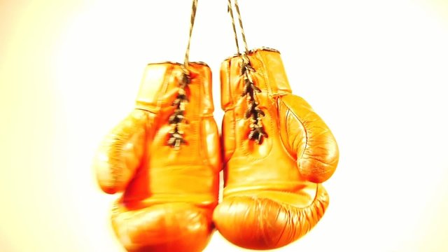 boxing gloves - one pair - red -  swinging - time lapse