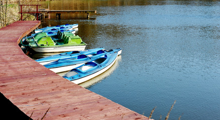 Kayaks on the lake attached to a wooden pier