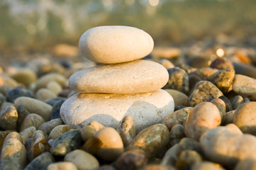 Fototapeta na wymiar three balanced rocks contrast a sea of stones