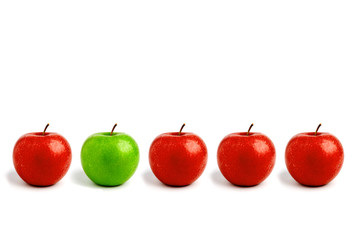 Row of apples, one green standing out