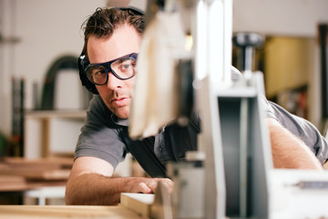 Carpenter using electric saw