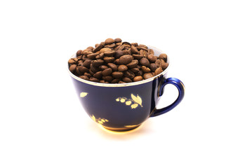 Old blue cup with coffee beans on white background. Isolated.