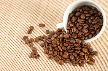 white cup with coffee beans