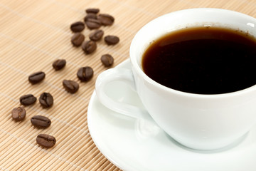 white cup of coffee and coffee beans