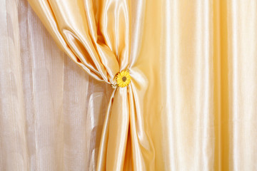Golden silk curtains with a clip