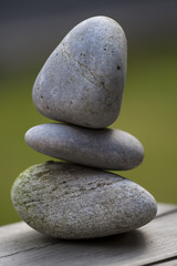 Three Stones Balanced on Wood