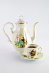 Beautiful old coffee pot and cup with a drawing