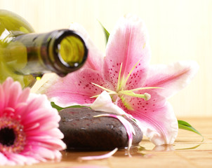 Spa background with flowers, stones and a bottle