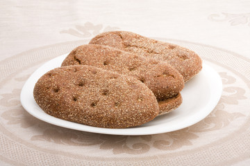 Dish of bread on a brown cloth
