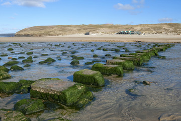 Stepping stones across a stream to the beach in Perranporth.