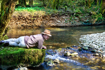 Adventurer lying next to a river