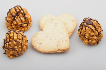 Homemade cookies - hearts and cakes on white