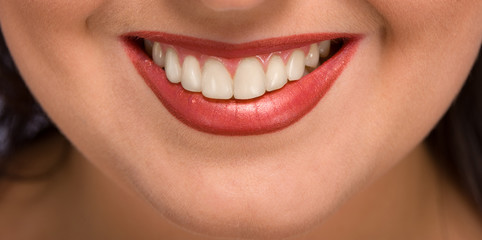 beautiful womanish smile, even white teeth are visible