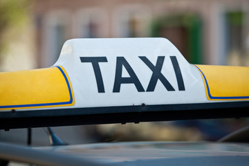 Taxi sign on a car roof - close-up