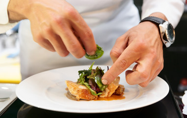 Chef is decorating delicious dish
