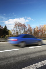 Speeding concept - Cars moving fast on a highway on a lovely a