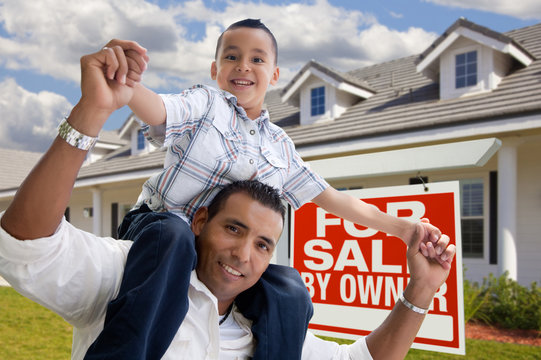 Hispanic Father and Son with For Sale By Owner Sign