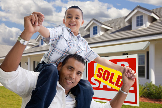 Hispanic Father and Son with Sold Real Estate Sign