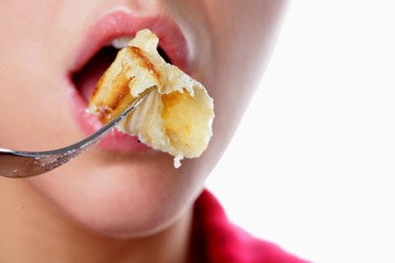 Young Woman Eating a Pancake. Model Released