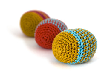 three colored knitted hacky sacks or footbag trio