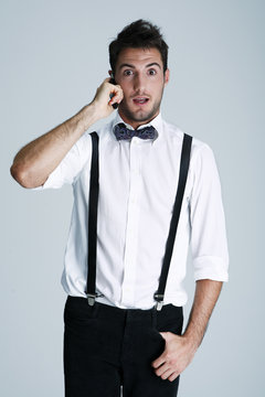 Young man in suspenders on the phone