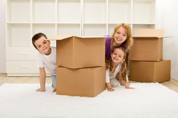 Happy kids and woman in a new home