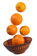 bowl of oranges floating in the air on a white background