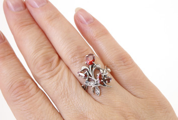 Ring with a red pomegranate on a finger