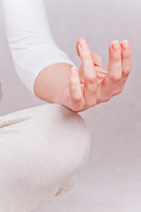 One hand of meditating woman in lotos pose - obrazy, fototapety, plakaty