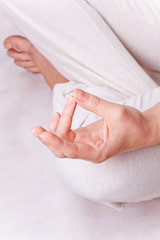One hand of meditating woman in lotos pose - obrazy, fototapety, plakaty