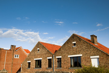 Fototapeta na wymiar Brick houses on clear blue sky