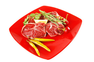 raw beef medallion on red