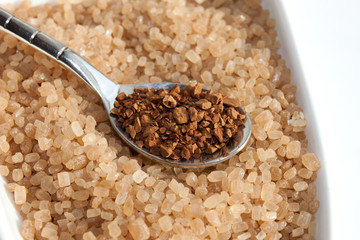 Spoon with coffee against sugar