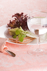 Fresh green salad with glass of water.
