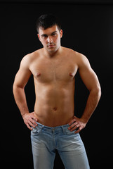 Fototapeta premium a handsome young man posing on a black background