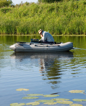A fisherman in a rubber boat