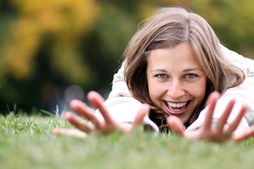 beautiful young woman relaxing in the grass