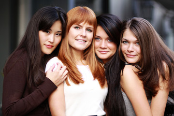 Close-up portrait of four urban women outside